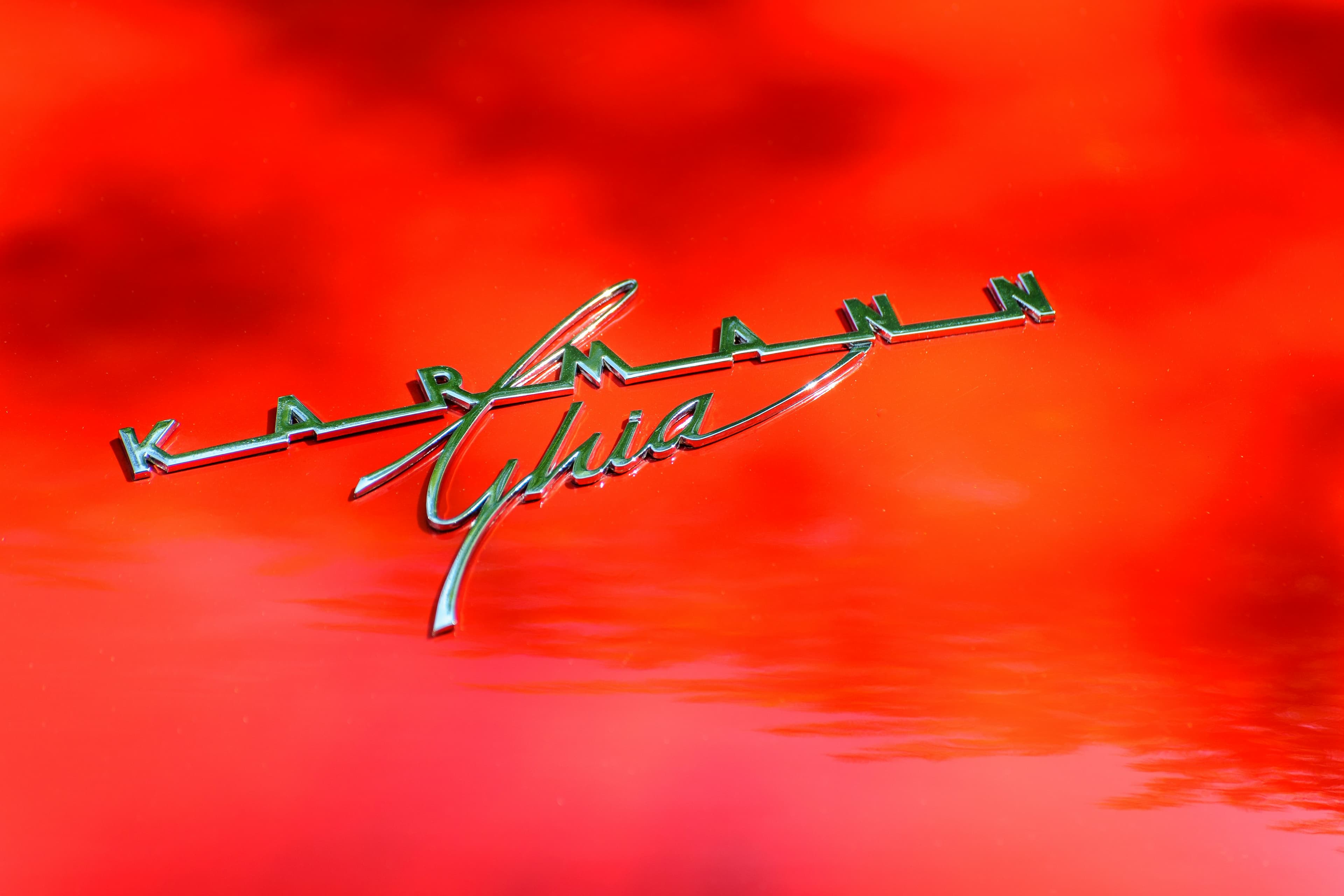 Karmann Ghia badge on red paint